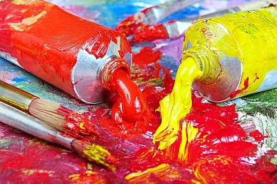 Palette of the artist with tubes of paint