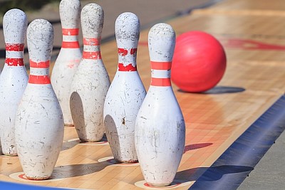 Skittles and bowling ball on the outdoor playing f