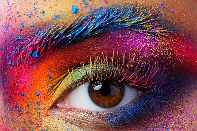 Female eye with bright multicolored fashion makeup