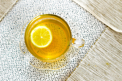 Above view of a glass of tea with lemon slice on a