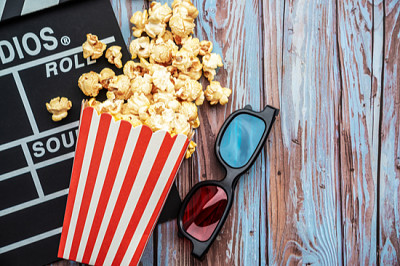 Cinema movie items, clapperboard, pop corn and 3d  jigsaw puzzle