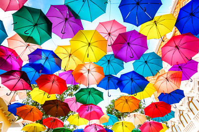 Multi-colored umbrellas background. Colorful umbre