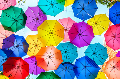 Multi-colored umbrellas background. Colorful umbre