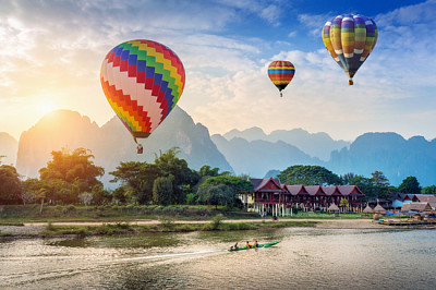 Hot air balloon over Nam Song river at sunset in V