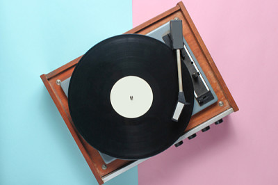 Vinyl player on a blue pink pastel background. Top