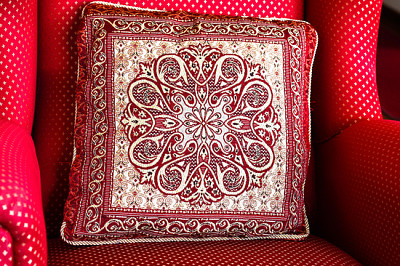 Red pattern pillow on red chair