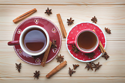 Tea for two, hot tea in red cups on wooden table