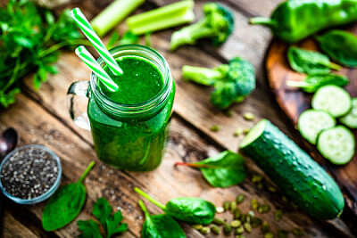 A top view of a glass of smoothie with broccoli