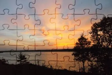 פאזל של Sunrays at dusk over Miramichi River