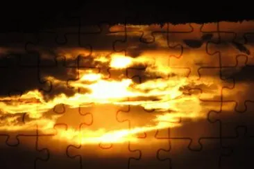 Setting sun peeking through dark clouds jigsaw puzzle