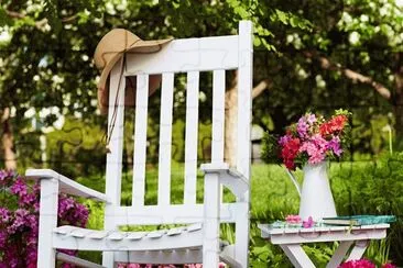 White Rocking Chair with Potted Azaleas
