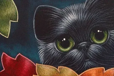 Black Kitten behind Fall Leaves