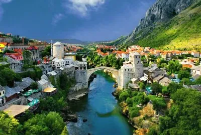 alpine_town_mountains_houses_bridge_