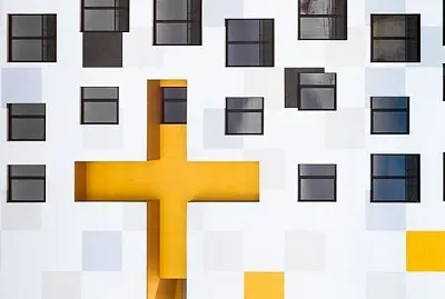 Yellow cross and white building