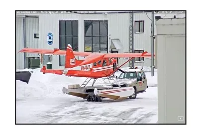 Half truck moving a small plane