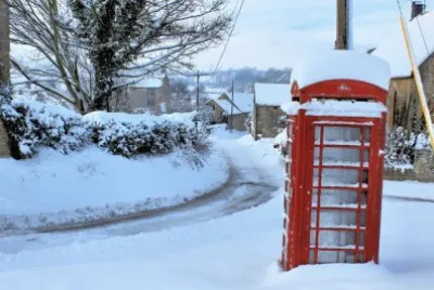 old red phone box in snow jigsaw puzzle