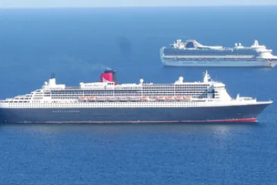 Queen Mary 2 anchored in Weymouth Bay with P O Cru