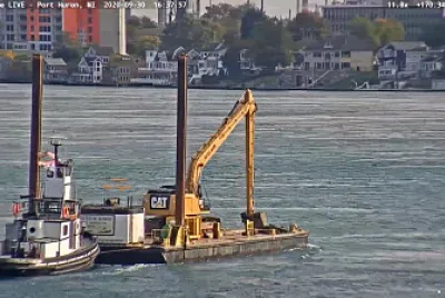 tug Capt Keith pushing a Spud-Barge with excavator