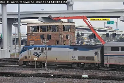 Amtrak engine 59 passing    "Tower-55 " being demolished