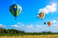 Air balloons flew over the spring fields