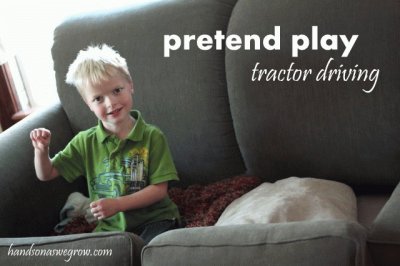 kid pretends to drive his tractor