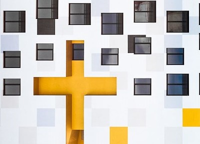 Yellow cross and white building
