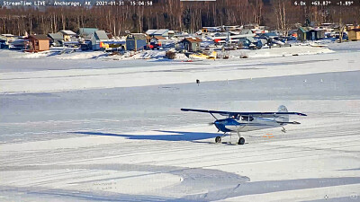 Ski landing on lake-2 blue plane