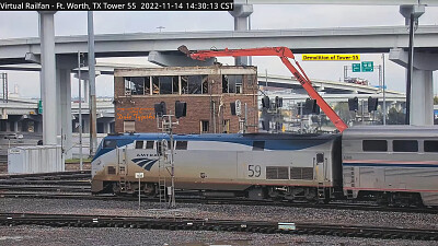 Amtrak engine 59 passing    "Tower-55 " being demolished